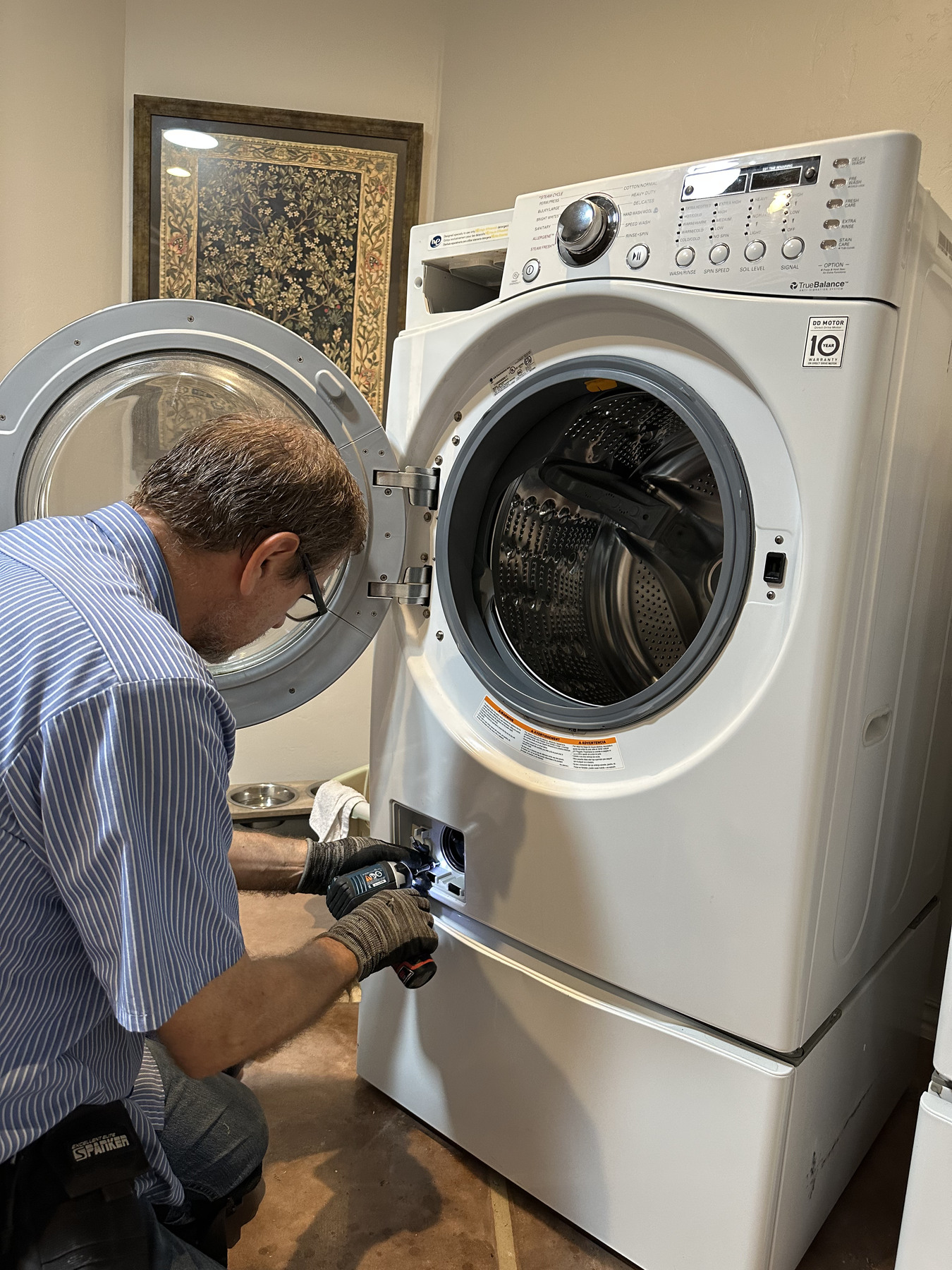 Vladimir repairing a front-loading washing machine