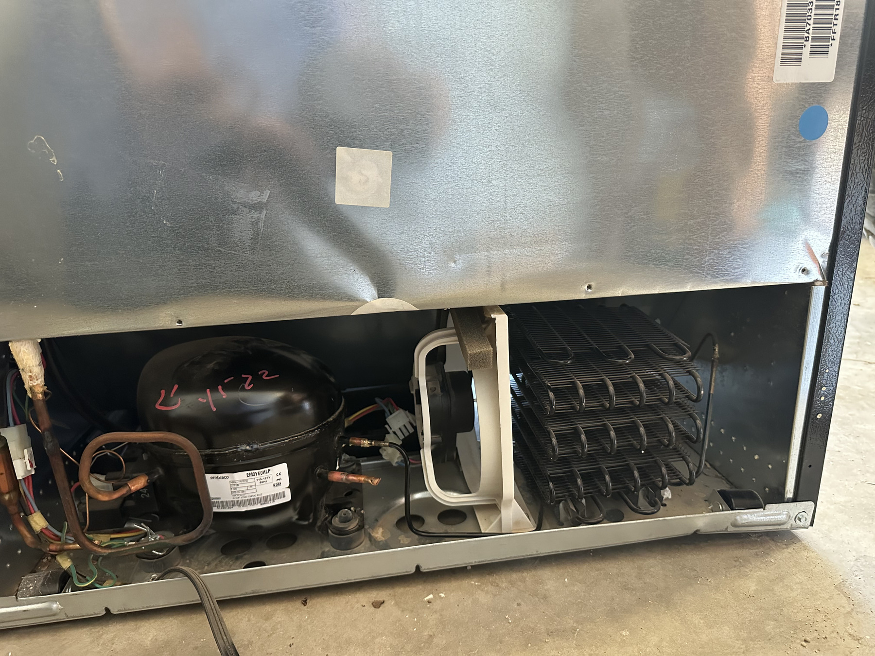 Refrigerator system being inspected and repaired